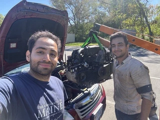 My great friend and master wrench, with the old engine up on the hoist behind us